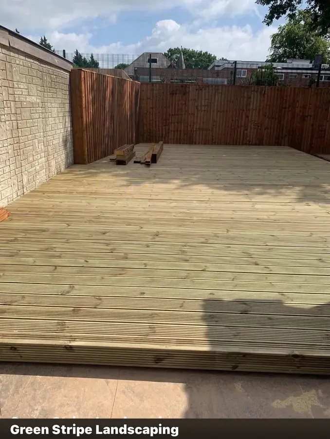 Timber deck built against a rendered wall with new fencing