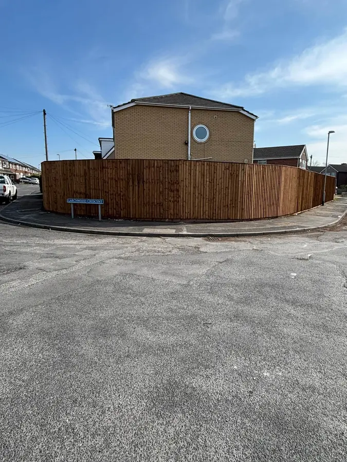 Tall new timber fence around a corner plot