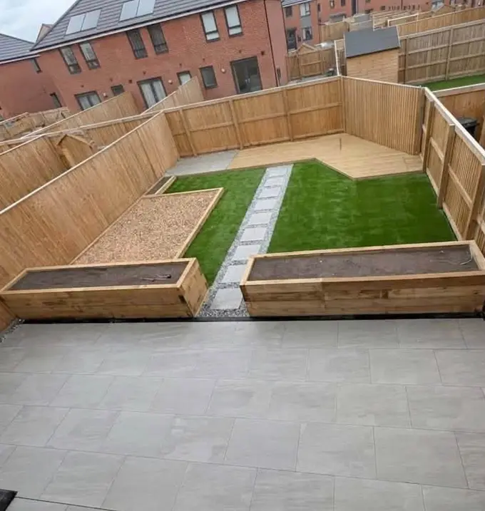 Sleeper beds and turf framed by new fencing with a porcelain patio