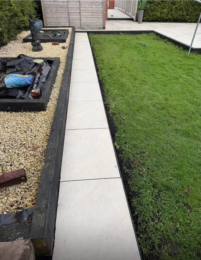 Porcelain path running beside a lawn with a sleeper edge